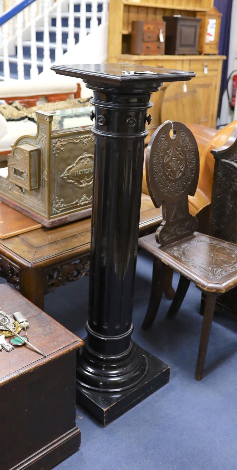 A late Victorian ebonised pedestal, height 110cm