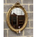 A Victorian style oval carved giltwood and gesso wall mirror, width 60cm, height 88cm