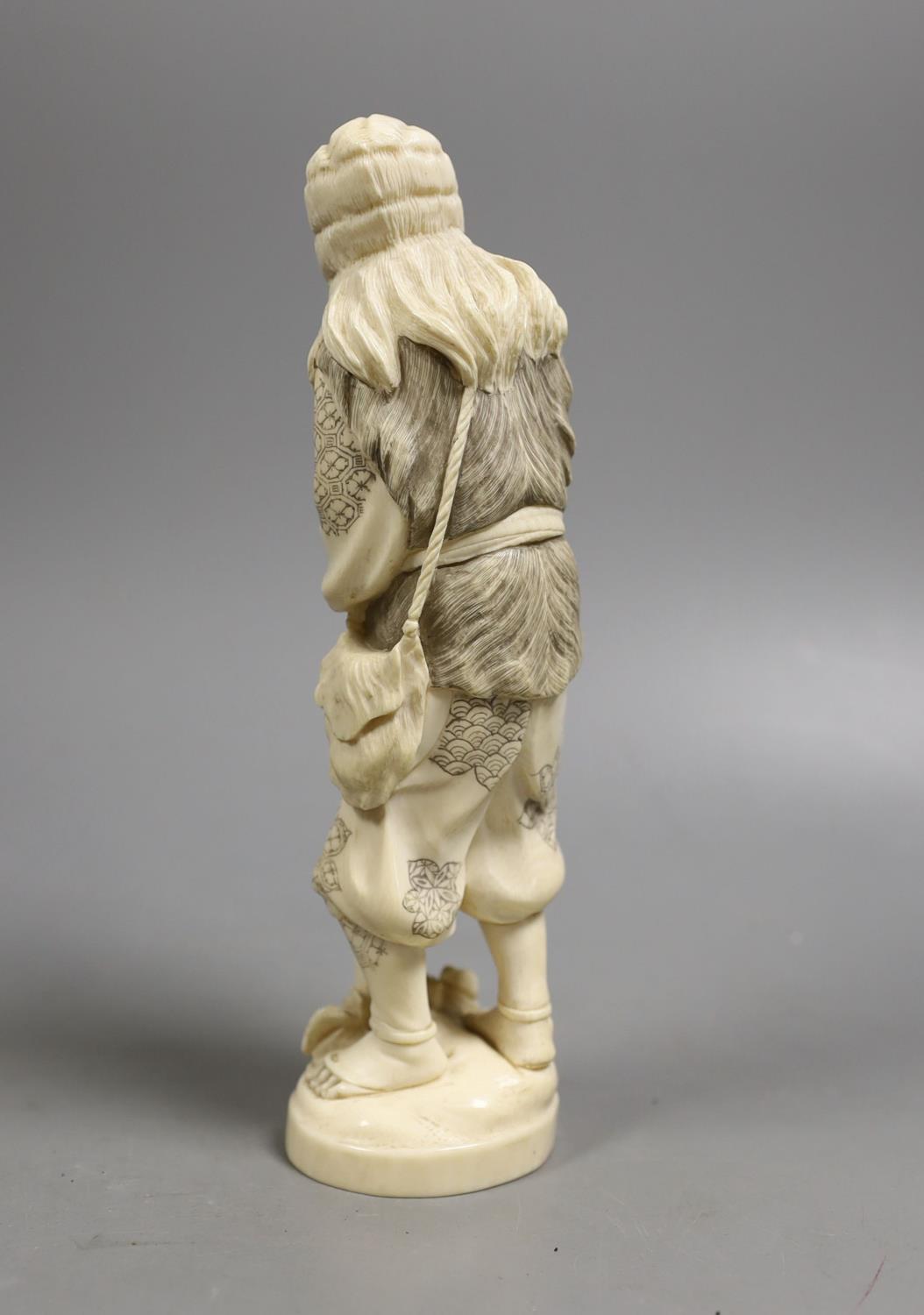 A Japanese ivory figure of a huntsman, early 20th century,21 cms high. - Image 2 of 4