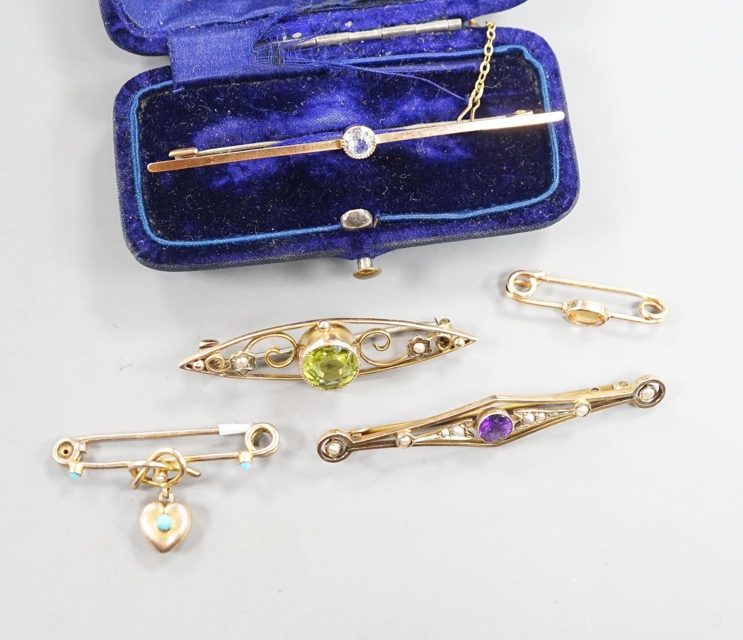 Five assorted early 20th century yellow metal and gem set brooches, including one 9ct and one with