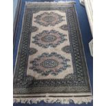 A Pakistan Bokhara style pink ground rug, 210 x 127cm