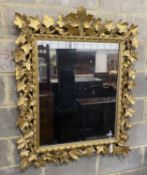 A late 19th century Florentine carved giltwood wall mirror with vineous frame width 97 cm Height 116