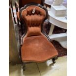 A Victorian carved walnut button back nursing chair