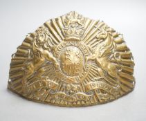 An embossed brass helmet-mount 19cm