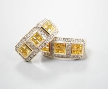 A modern pair of 14k yellow metal, diamond chip and triple cluster yellow sapphire? set half hoop