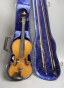 An early 20th century French or English violin with two bows, each stamped