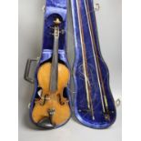 An early 20th century French or English violin with two bows, each stamped