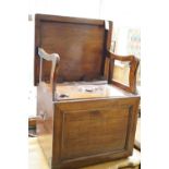 An early 19th century mahogany box commode with folding top and bone handled brass pump handle,