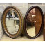 Two early 20th century oval simulated grain wall mirrors, larger width 68cm, height 96cm