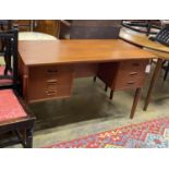 A mid century Danish teak kneehole dressing table of rectangular concave form, width 116cm, depth