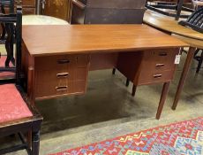 A mid century Danish teak kneehole dressing table of rectangular concave form, width 116cm, depth