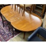 A mid century Danish teak circular extending dining table, two spare leaves, 220cm extended, width