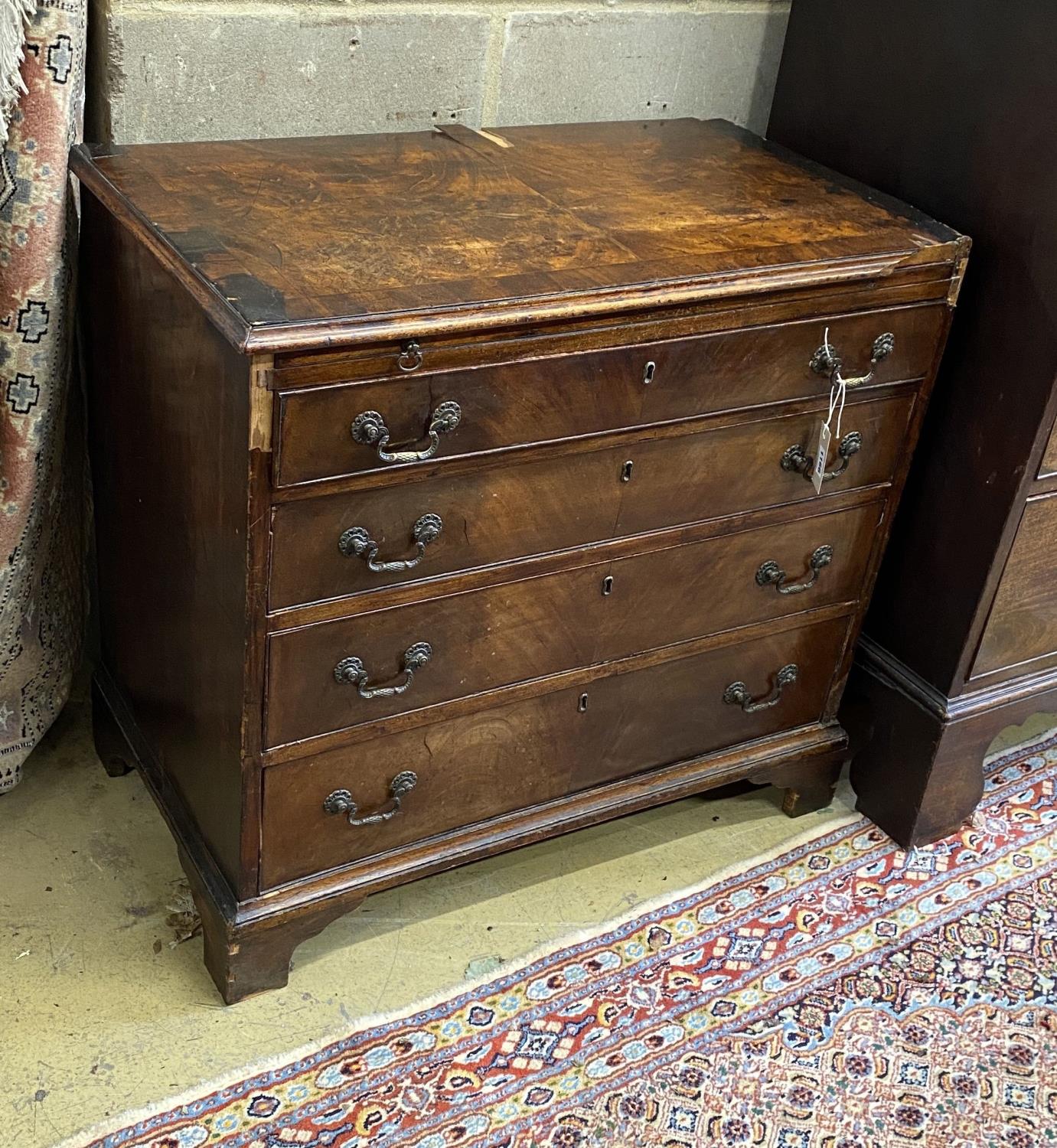A small George III provincial mahogany four drawer chest with brushing slide, in need of