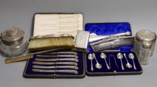 Four assorted silver mounted glass toilet jars, a silver mounted brush, two combs and a shoe horn