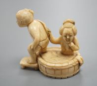 A Japanese ivory Netsuke of a bathing couple, Meiji period,3.5 cms high.