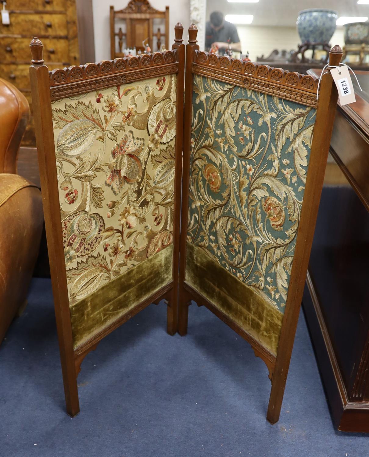 An Arts and Crafts Morris-style embroidered two-fold mahogany framed screen, each panel width