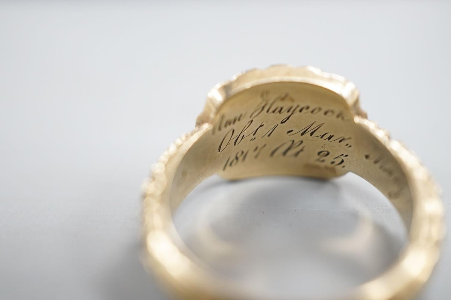 A late George III yellow metal, garnet and plaited hair mounted mourning ring, inscribed 'Ann - Image 7 of 8