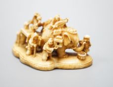 A Japanese carved ivory netsuke, mother of pearl inset to base with signature 'Gyokuzan', Meiji