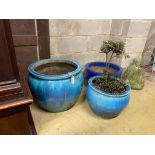 Three circular glazed earthenware garden planters, largest diameter 54cm, height 46cm