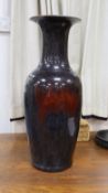 A large Chinese sang de boeuf glazed vase on carved wooden stand.Vase 61 cms high not including