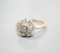 A yellow metal and eight stone diamond set flower head cluster ring, size M, gross weight 2.7