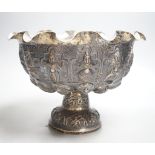 A late 19th century Burmese embossed white metal pedestal bowl, with wavy border, diameter, 27.