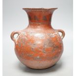 A pre-Columbian black and red pigment decorated two handled pot 25cm