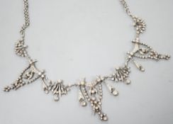 A 19th century white metal and paste set drop necklace, 37.5cm, in an associated gilt tooled