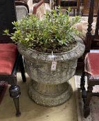 A circular reconstituted stone garden planter with ribbon fold moulded body, diameter 58cm, height