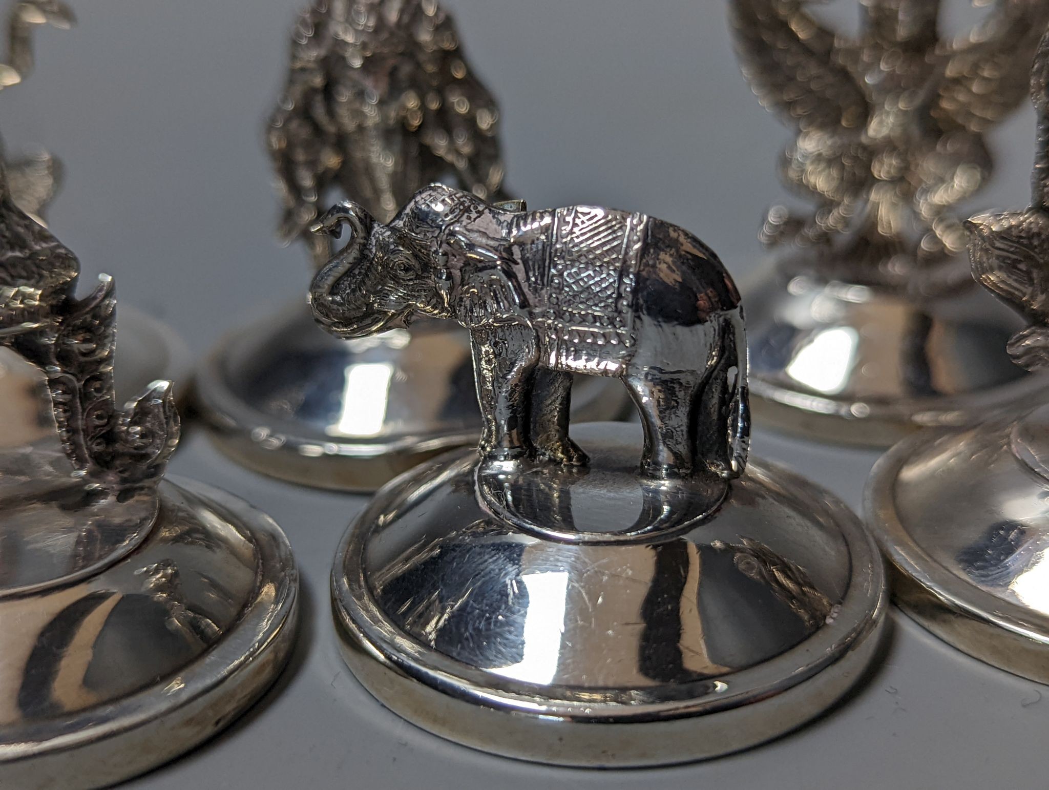 Sixteen assorted Siamese sterling mounted menu holders, modelled with figures, elephant, etc. - Image 10 of 17