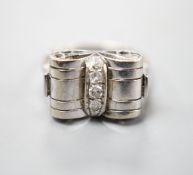 A 1940's white metal and three stone diamond set dress ring, size P, gross weight 3.5 grams.