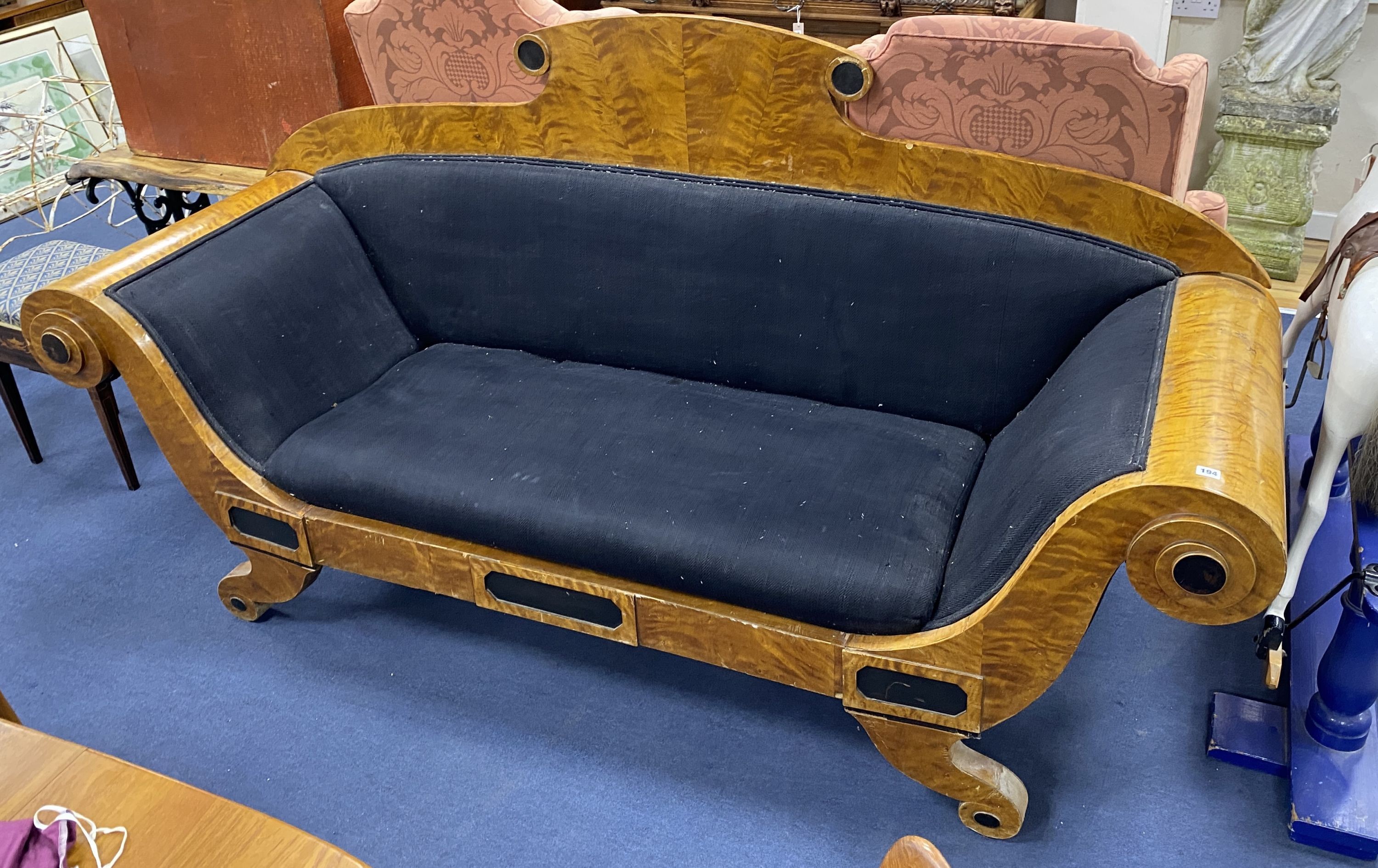 A Biedermeier style part ebonized birch scroll arm settee upholstered in black fabric width 230,