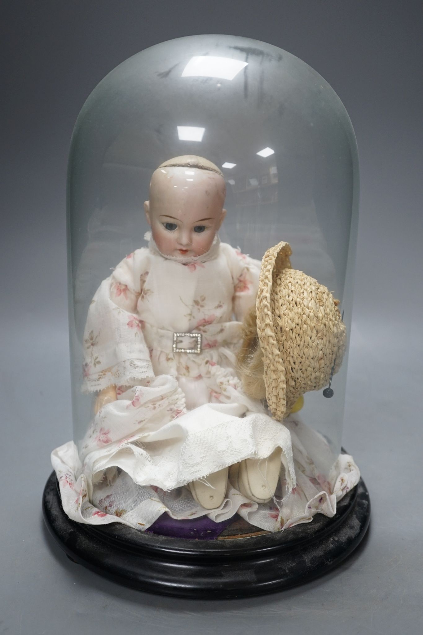 An Armand Marseille bisque doll, mould 1894, under glass dome 29cm