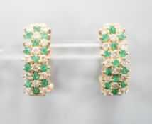 A pair of 14k yellow metal, emerald and diamond set curved earrings, 19mm, gross weight 7.4 grams.