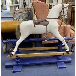 An early 20th century rocking horse on painted safety frame, (re-painted) width 126cm, height 114cm