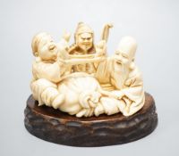 A Japanese ivory okimono of the gods Daikoku, Bishamonten and Fukurokuju, Meiji period, signed to