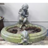 An early 20th century oval lead garden fountain formed as a seated satyr playing pan pipes with