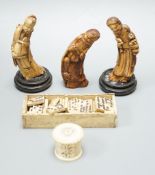 Three Chinese carved hippo tooth figures of Immortals, a 19th-century bone boxed dominoes set and