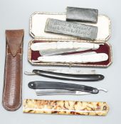 A leather cased pair of mother-of-pearl handled cut throat razors, by J Crawford and three other