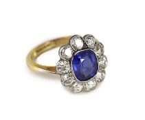 An 18ct gold and platinum, synthetic sapphire and diamond set oval cluster ring,size H, gross weight