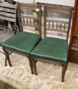 A pair of late Victorian carved oak dining chairs