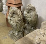 A pair of reconstituted stone owl garden ornaments, height 47cm