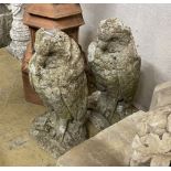 A pair of reconstituted stone owl garden ornaments, height 47cm