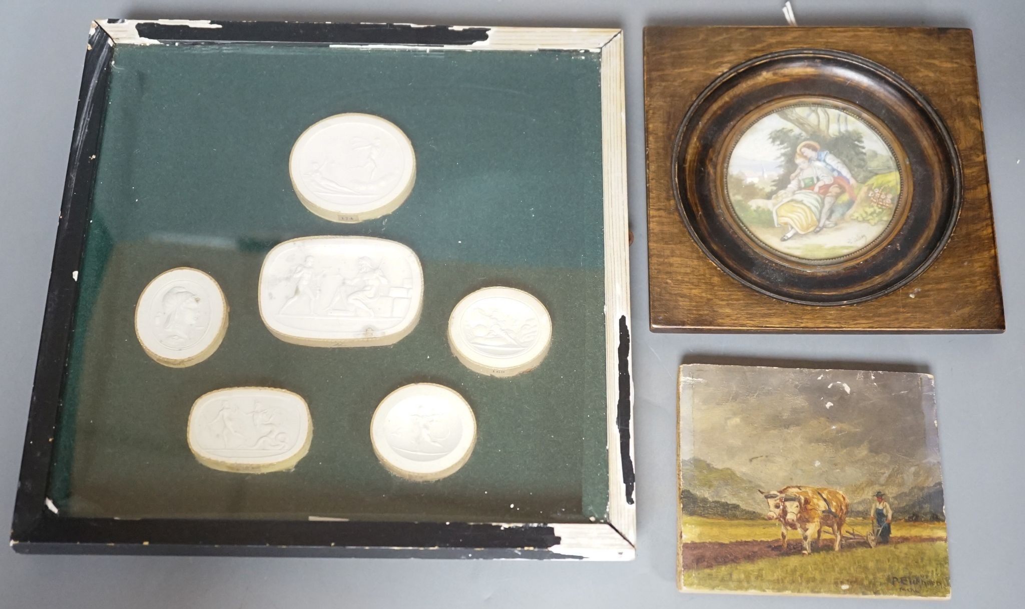 A framed group of classical plaster reliefs and two small paintings