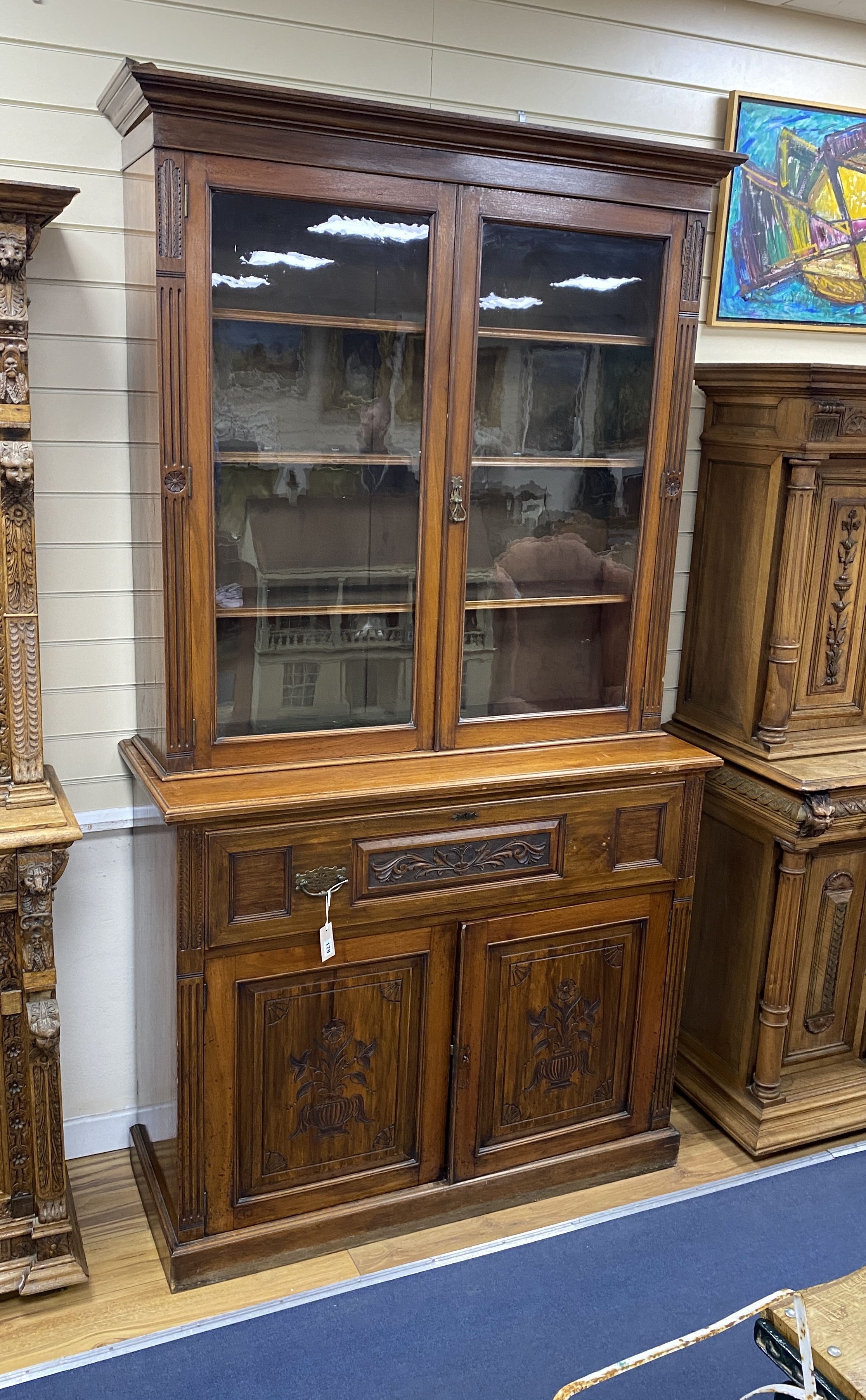 A late Victorian carved walnut secretaire bookcase, length 122cm, depth 48cm, height 226cm