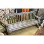 A weathered teak garden bench, length 182cm, depth 52cm, height 90cm