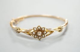 An early 20th century yellow meta diamond and seed pearl set hinged bangle, gross 9.5 grams.