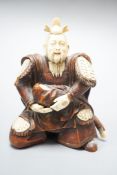 A Japanese wood and ivory okimono of a kneeling samurai holding a baby, Meiji period, unsigned,