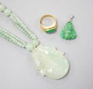 A carved jade pendant, 53mm on a quartz bead necklace, one other jade pendant and a jade, paste