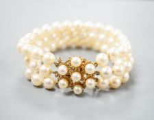 A triple strand cultured pearl bracelet, with yellow metal and cultured pearl cluster set clasp,